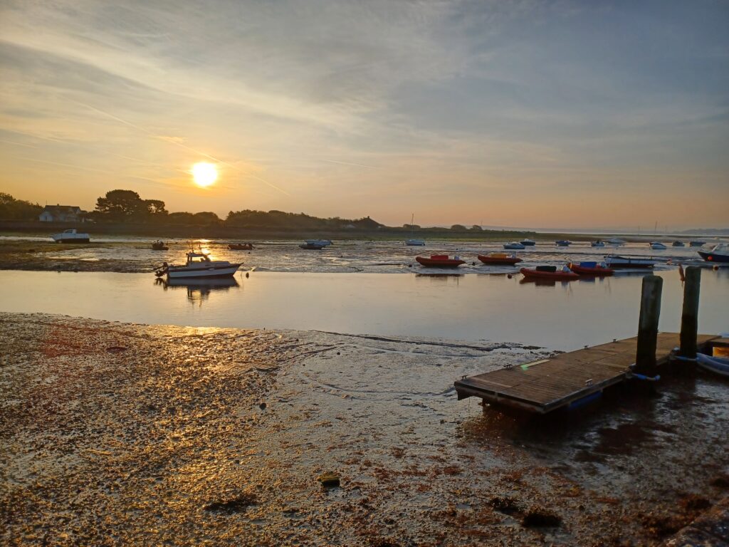 a calm serene sun set over the isle of wight viewed from the sea