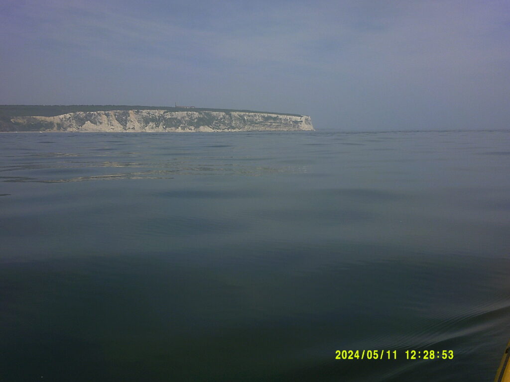 calm serene waters around the isle of wight, the view of the needles from the sea